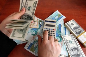 A dealer counts the dollar banknotes as