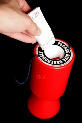 Person giving twenty pounds to charity